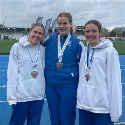 Three Loreto Toorak students smiling with their medals