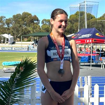 Cleo (Year 10) receiving her silver medal for 1500m